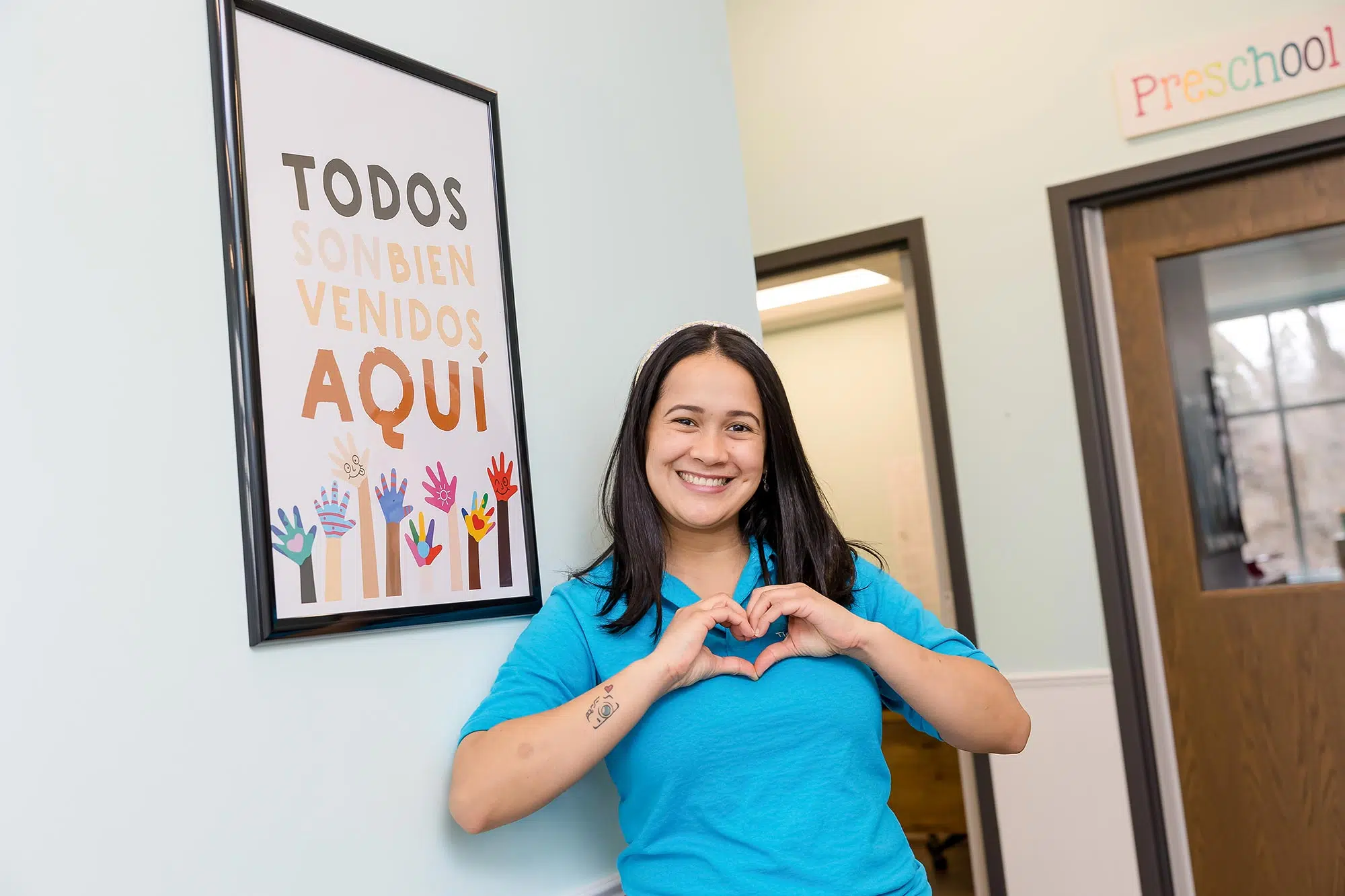 Teacher making a heart symbol with her hands scaled e1680629824517.jpg